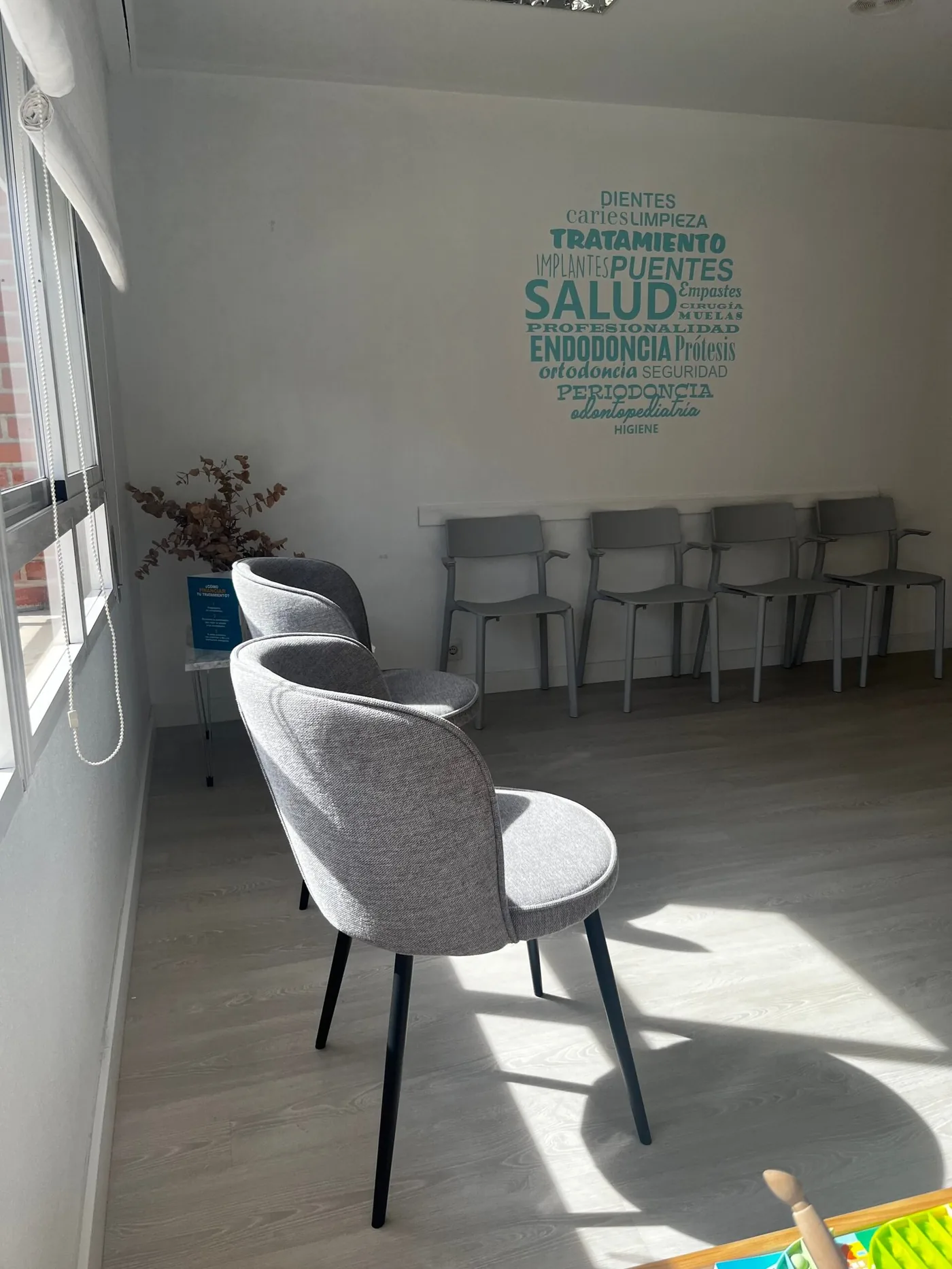Sala de espera de la clínica con el mural de palabras al fondo